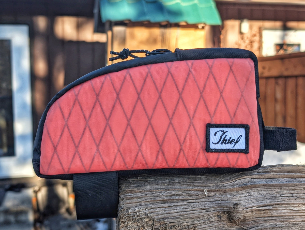 Thief Bikepacking Snack Break coral Xpac top tube bag with diamond pattern and black trim