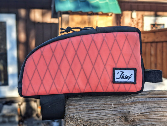 Thief Bikepacking Snack Break coral Xpac top tube bag with diamond pattern and black trim